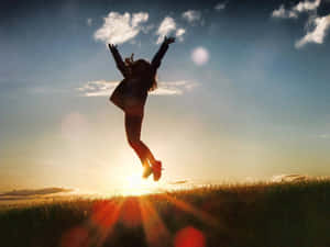Resilient Person Jumping In Joy Wallpaper