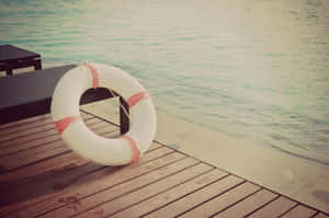 Retro Summer Lifebuoyon Wooden Dock.jpg Wallpaper