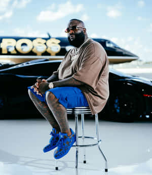 Rick Ross Stylish Pose With Cars And Jet Wallpaper