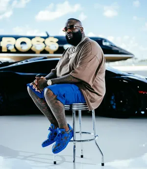 Rick Ross Stylish Pose With Cars And Jet Wallpaper
