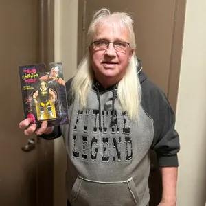 Ricky Morton Holding Action Figure Wallpaper