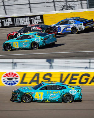 Ricky Stenhouse Jr., In His Dazzling Blue Racing Car, Vying For A Position On The Race Track. Wallpaper