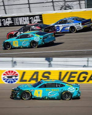 Ricky Stenhouse Jr., In His Dazzling Blue Racing Car, Vying For A Position On The Race Track. Wallpaper