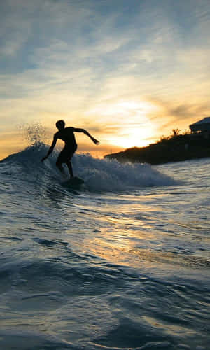 Ride The Waves With This Epic Surfing Iphone Wallpaper Wallpaper