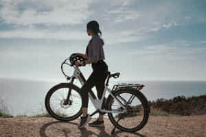 Riding An Electric Bike On A Scenic Route Wallpaper
