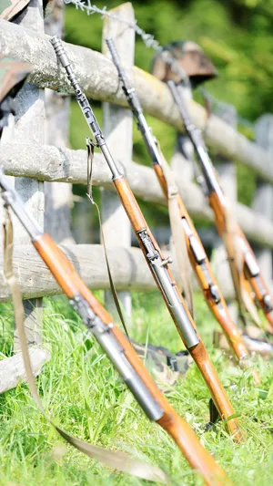 Rifles Leaning Against Fence Wallpaper