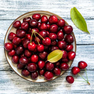 Ripe Black Cherry Hangs On A Branch, Ready For Harvest Wallpaper