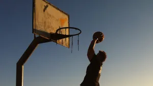 Rise To The Occasion – On Court Basketball Action Wallpaper