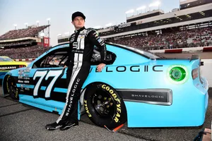 Rising Star Justin Haley In His Aqua Blue Race Car Wallpaper