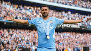 Riyad Mahrez Celebrating With His Champion Medal Wallpaper