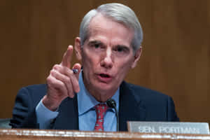 Rob Portman Expressively Gesturing During A Discussion Wallpaper