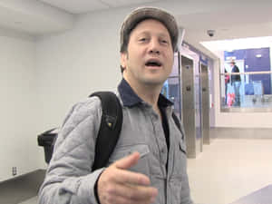 Rob Schneider With Tmz In Airport Wallpaper