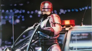 Robocop Standing By Police Car Wallpaper