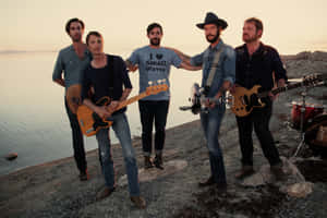 Rock Band At Sunset By The Sea Wallpaper