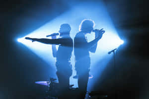 Rock Concert Silhouettes Blue Lights Wallpaper