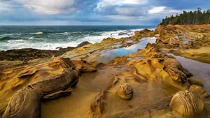 Rock Formations At A Lush Coastal Beach Wallpaper