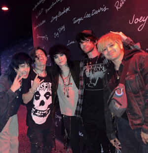 Rock Group Posing At Venue Wall Wallpaper