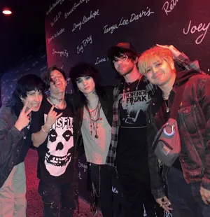 Rock Group Posing At Venue Wall Wallpaper