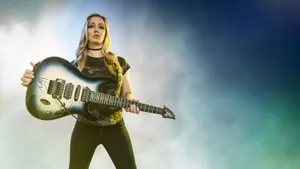 Rock Guitarist Holding Instrument Wallpaper