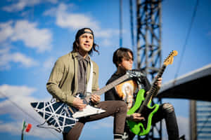 Rock Guitarists Performing Outdoors Wallpaper