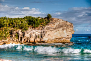 Rocky Cliff And Sandy Beach Wallpaper