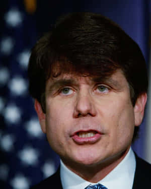 Rod Blagojevich Speaking With Us Flag Wallpaper