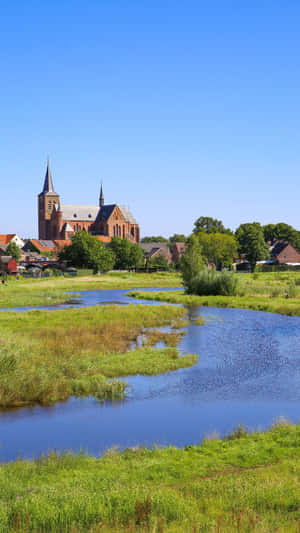 Roermond Church Over Water Meadow Wallpaper