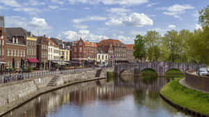 Roermond River Viewwith Stone Bridge Wallpaper