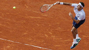 Roger Federer Serving At The French Open Wallpaper