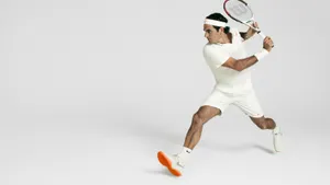 Roger Federer Showcasing His Agility On The Tennis Court. Wallpaper