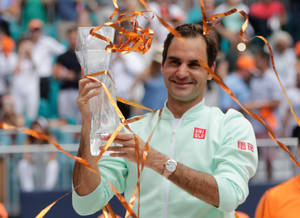 Roger Federer Triumphantly Holding A Crystal Trophy Wallpaper