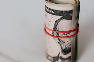 Rolled U S Dollarswith Rubber Band Wallpaper