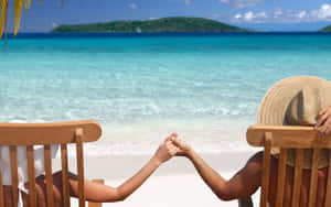 Romantic Beach Stroll At Sunset Wallpaper