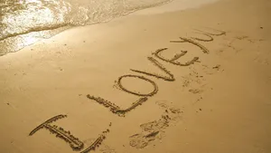 Romantic Couple Embracing On A Beach At Sunset Wallpaper