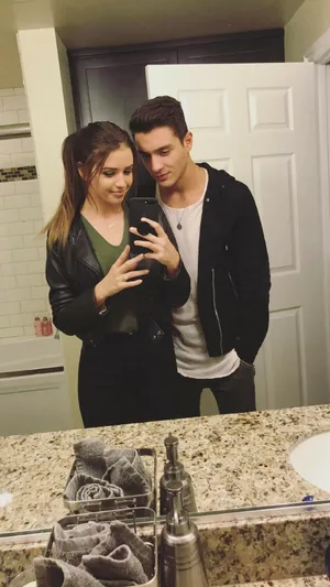 Romantic Couple Enjoying A Sunset Hug Wallpaper