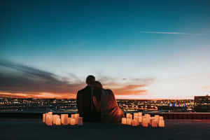 Romantic Couple Enjoying Sunset Together Wallpaper