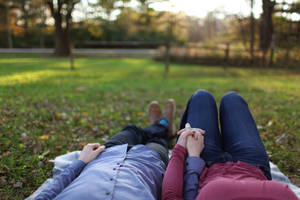 Romantic Couple Holding Hands On The Ground Wallpaper