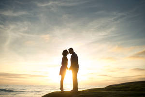 Romantic Couple In Golden Hour Wallpaper