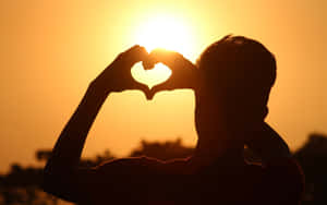 Romantic Heart Silhouette At Sunset Wallpaper