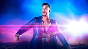 Romeo Santos Performing Under Stage Lights Wallpaper