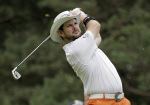 Rory Sabbatini In Mid-swing On The Golf Green Wallpaper