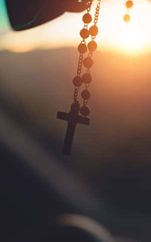 Rosary Sunset Glow Wallpaper