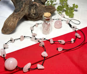 Rose Quartz Crystal Necklaceand Bottle Wallpaper