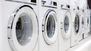 Rowof Washing Machinesin Store Wallpaper