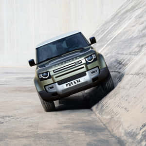 Rugged And Capable Land Rover Defender On The Move Wallpaper