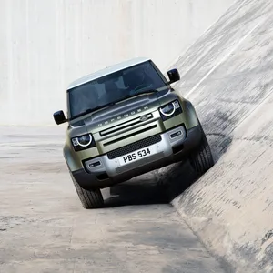 Rugged And Capable Land Rover Defender On The Move Wallpaper