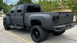 Rugged Gmc Topkick Truck Against A Breathtaking Cityscape Wallpaper