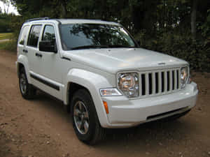 Rugged Jeep Liberty Suv On Adventure-filled Terrain Wallpaper