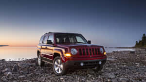 Rugged Jeep Patriot On A Scenic Off-road Adventure Wallpaper