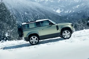 Rugged Land Rover Defender Off-roading In The Wild Wallpaper